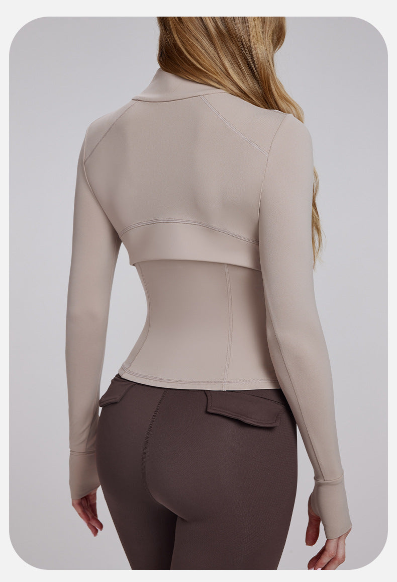 Woman wearing beige cropped jacket and brown leggings in Slim Fit Breathable Yoga Jacket for fashion and ملابس