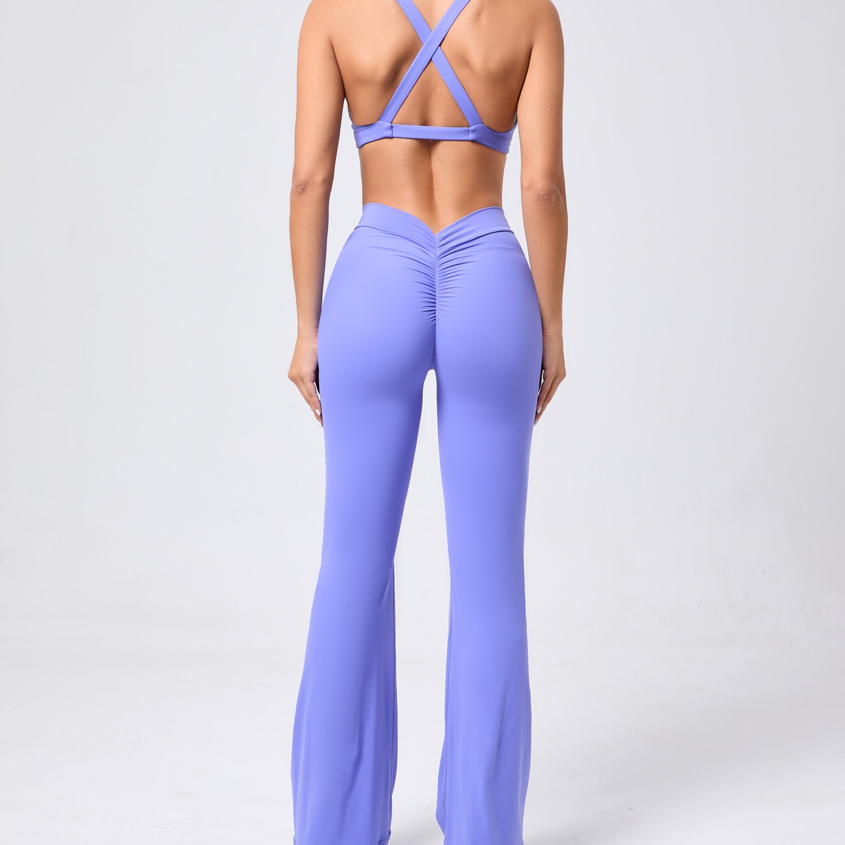 Peach hip raise tight brushed yoga jumpsuit with lavender crisscross backless design
