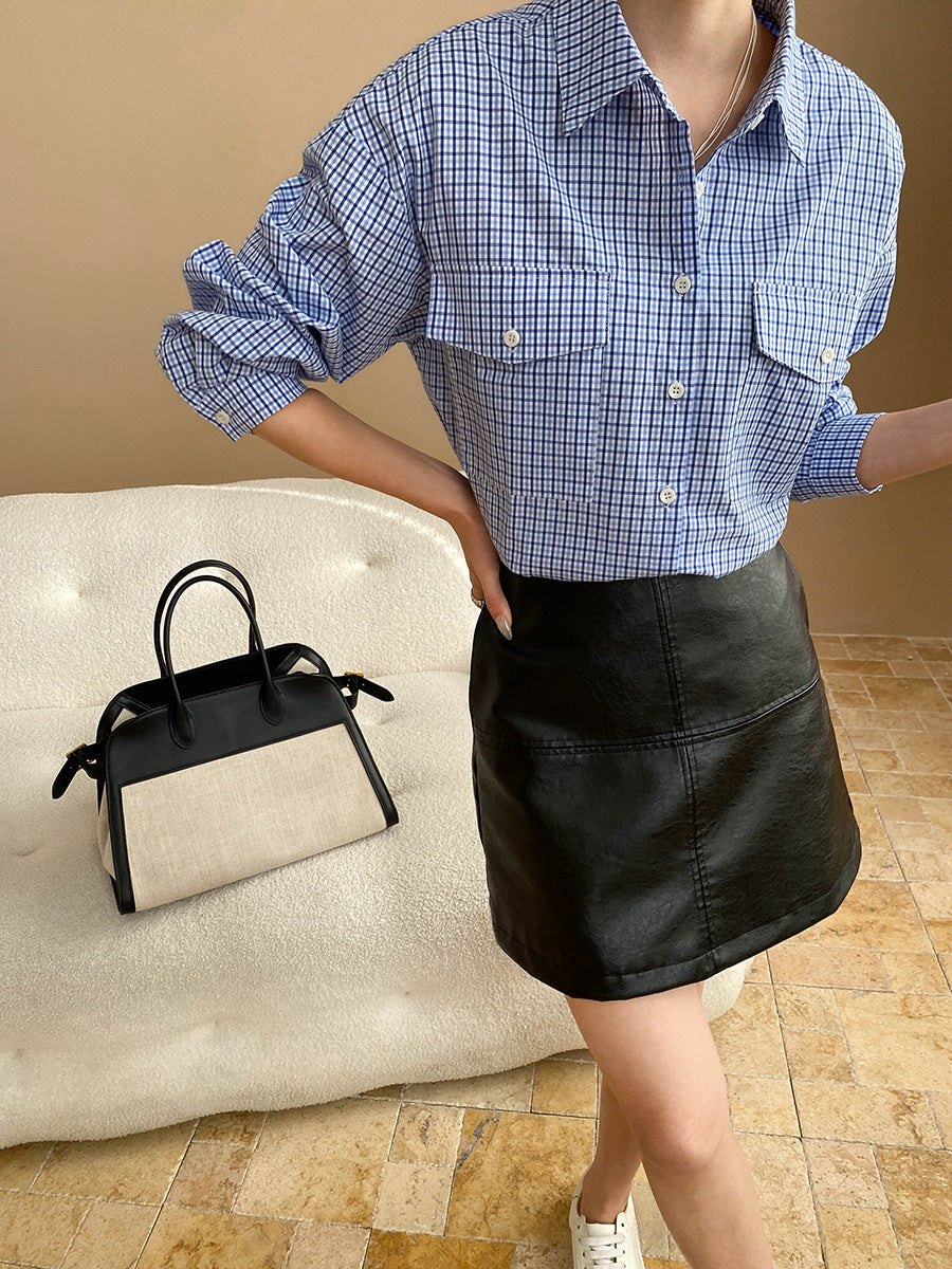 Black and white color-blocked handbag with black handles for a long sleeve fashion look