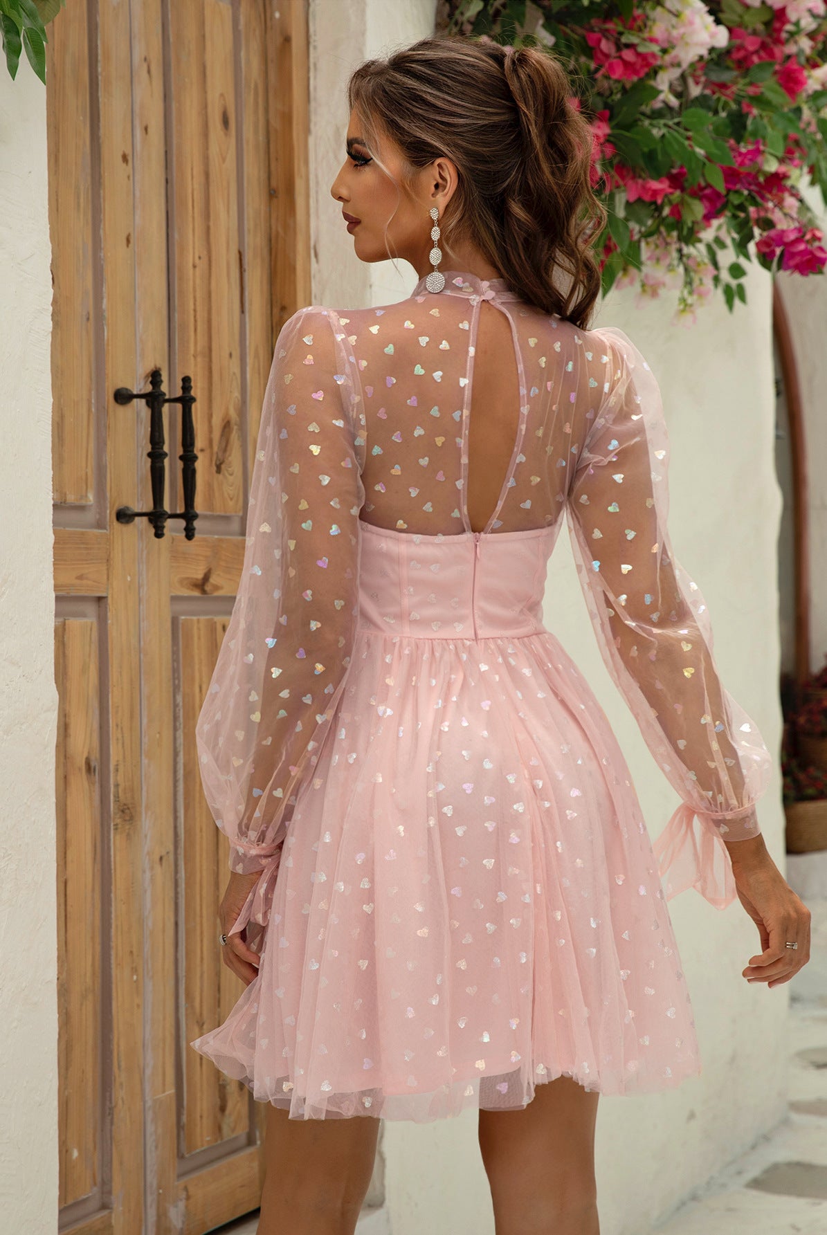 Elegant Barbie Dress featuring a pink tulle design with sheer polka dot sleeves and an open back