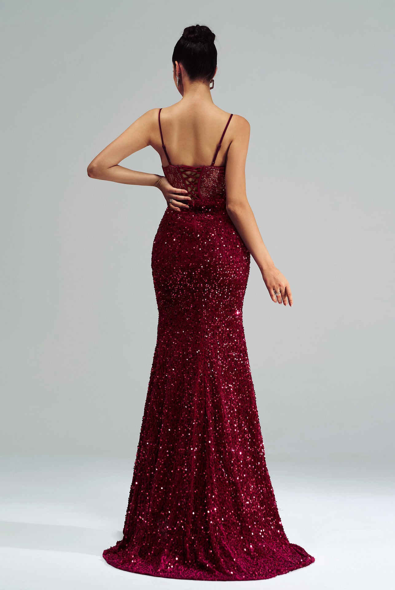 Burgundy sequined mermaid gown with spaghetti straps and a sweeping train for elegant fashion