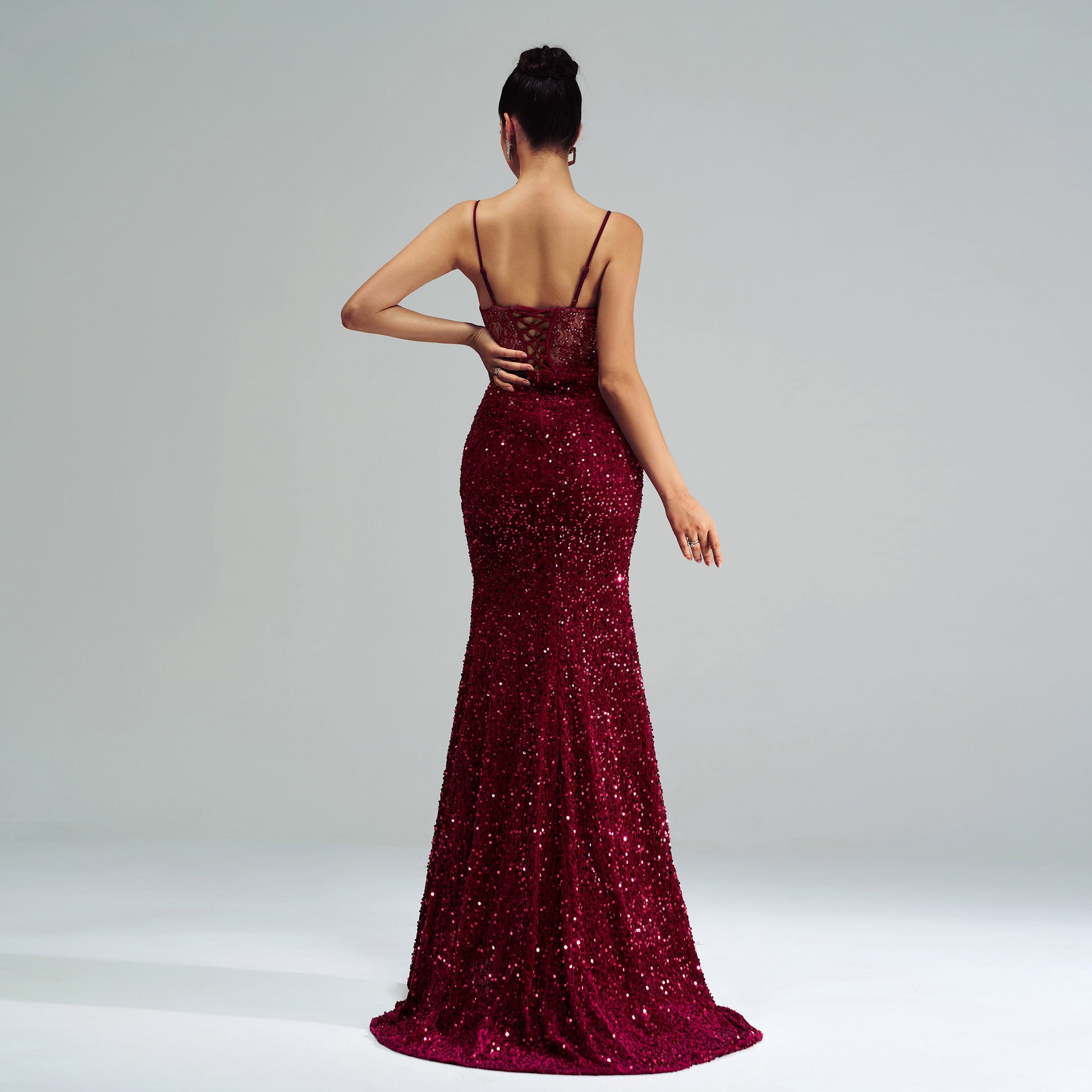 Burgundy sequined mermaid gown with spaghetti straps and a sweeping train for elegant fashion