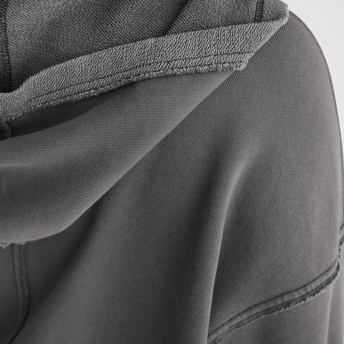 Gray hooded sweatshirt showcasing fabric texture and seam details for langry fashion ملابس