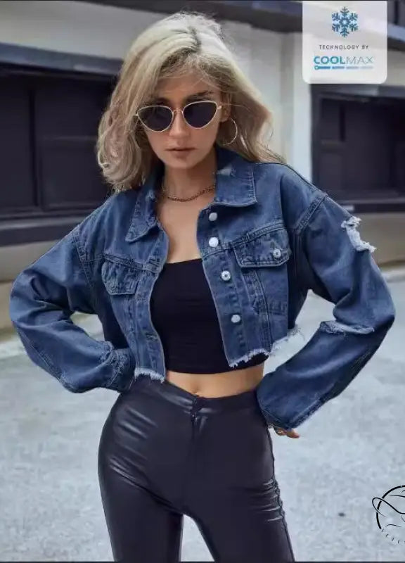 Woman in matching denim short coat with black crop top and leather pants