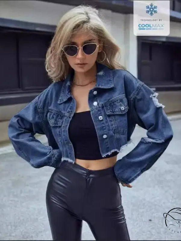 Woman in matching denim short coat with black crop top and leather pants