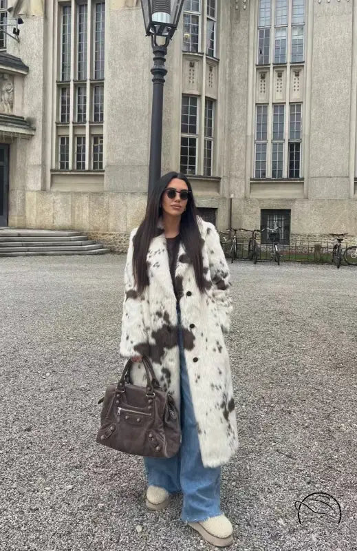 Cozy faux fur long coat in cow print with brown and white spots