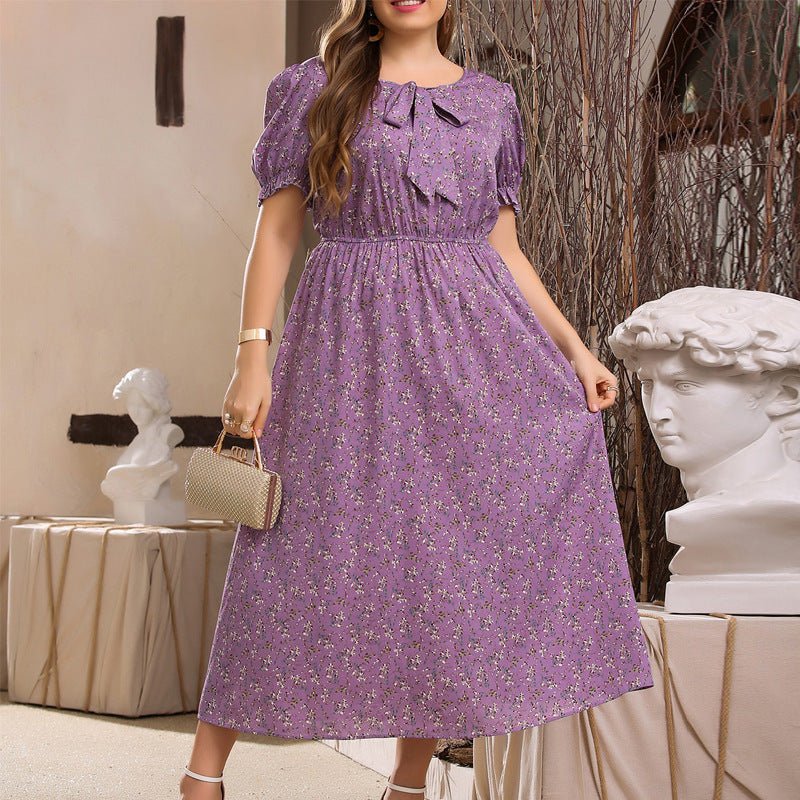 Purple floral midi dress with puff sleeves and bow neckline for stylish summer fashion