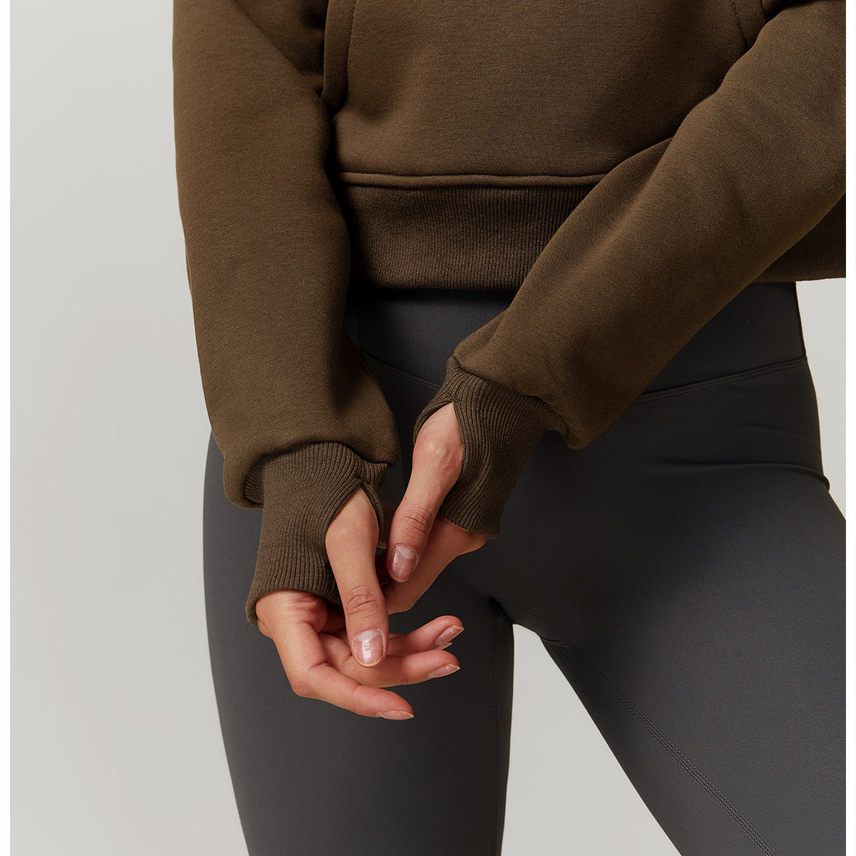 Hands clasped behind a person in a Winter Fleece Loose Sweater, showcasing langry fashion ملابس