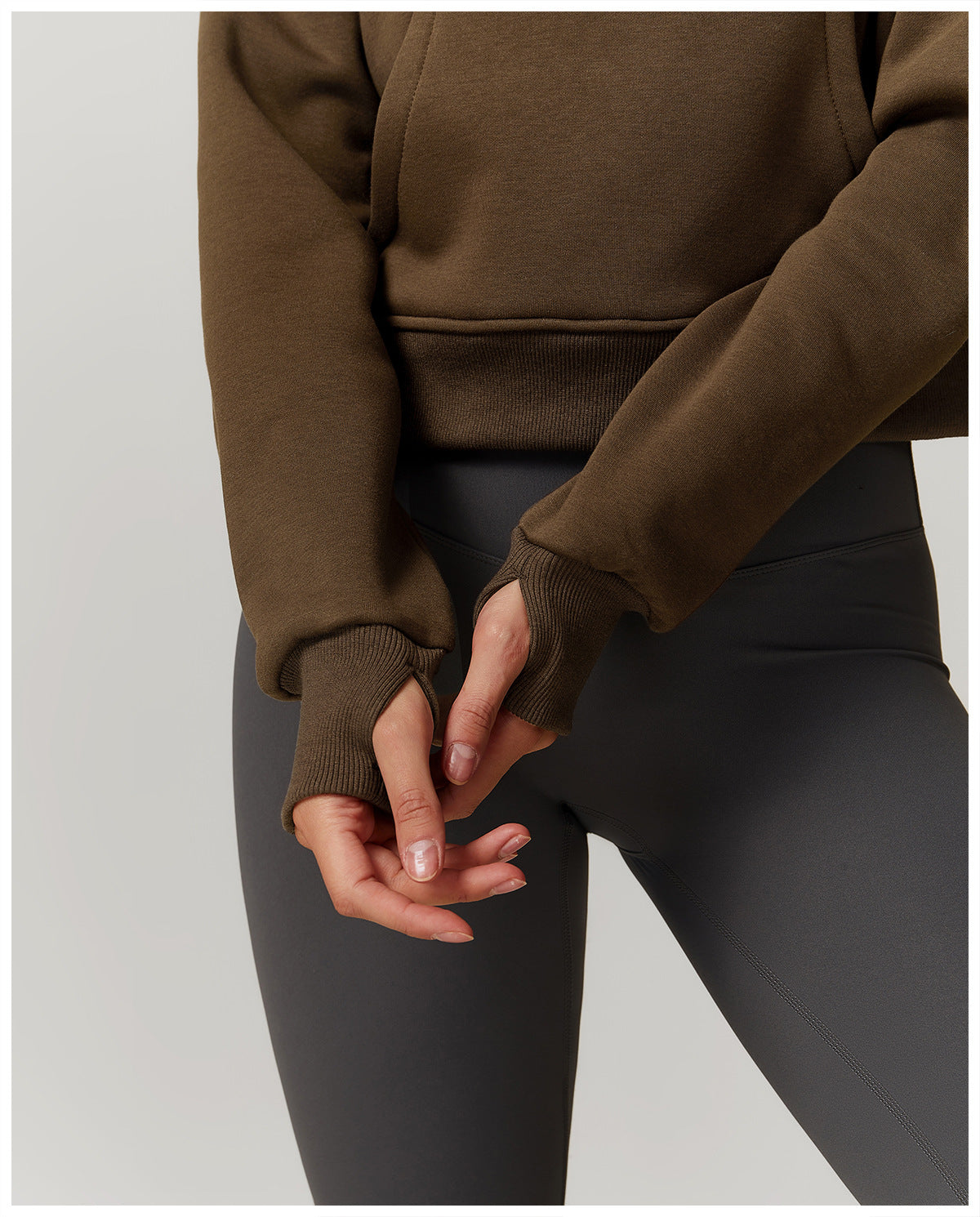 Hands clasped behind a person in a Winter Fleece Loose Sweater, showcasing langry fashion ملابس