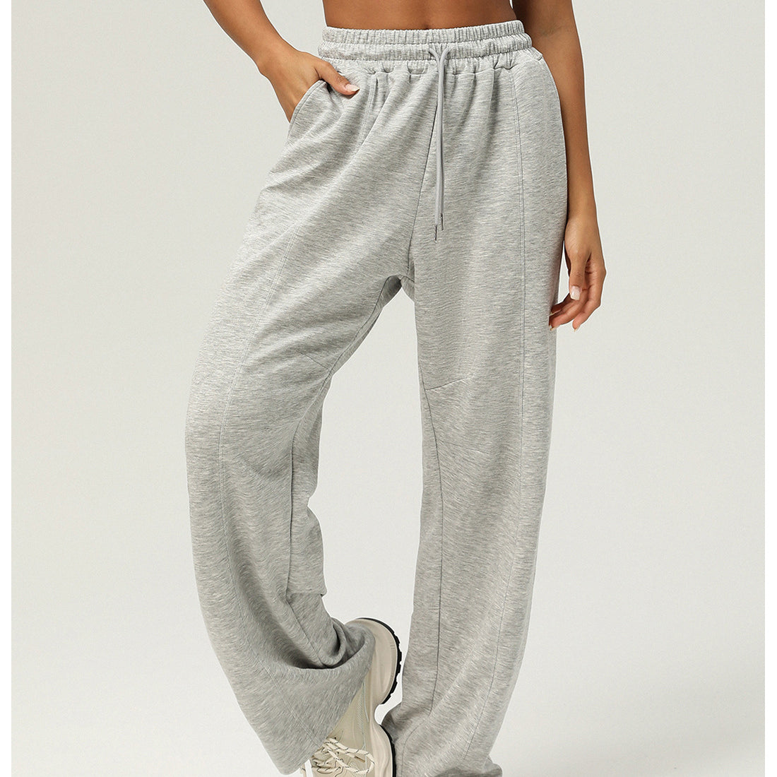 Light gray sweatpants with elastic waistband and pockets for casual fitness yoga wear