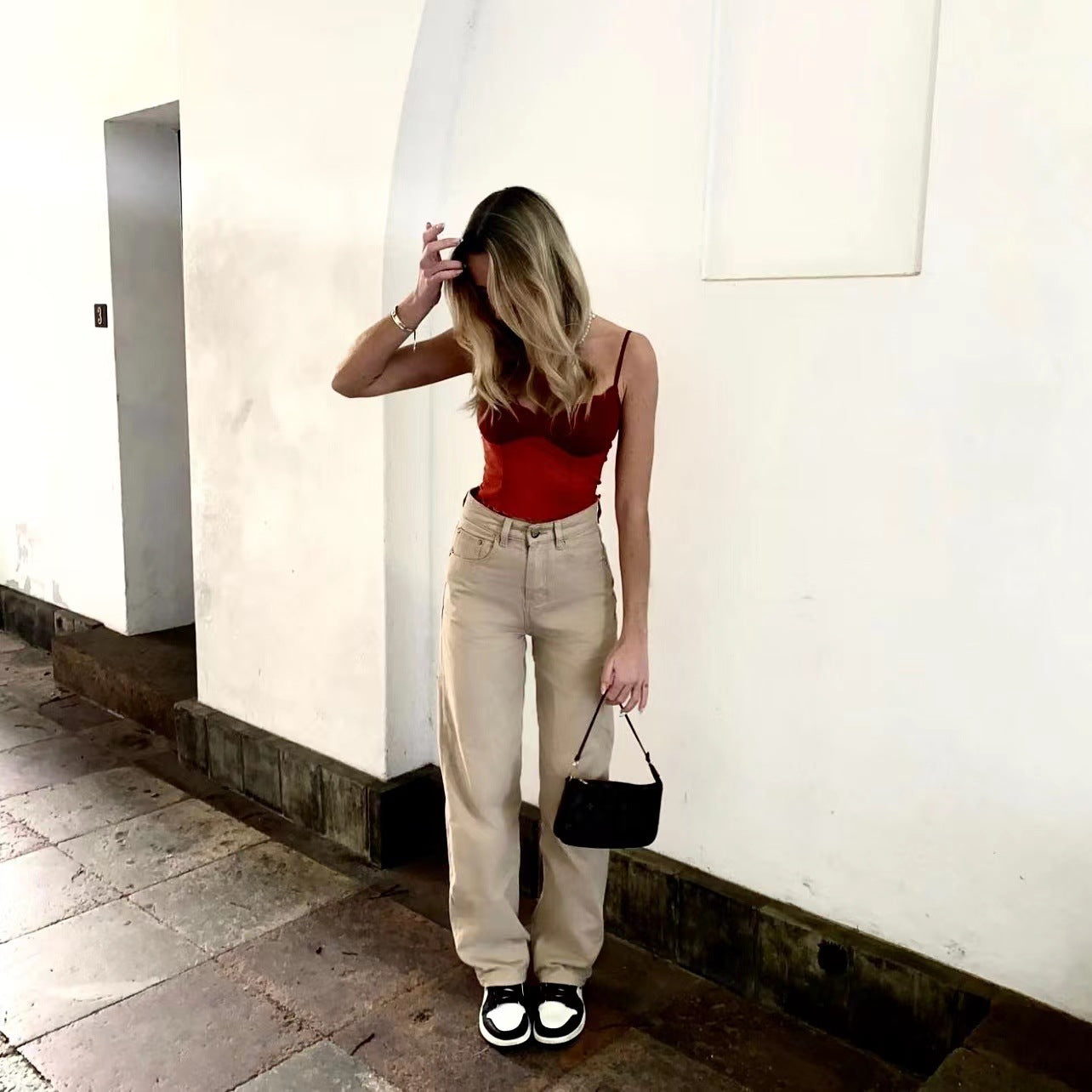 Woman wearing red top and beige Retro Light Khaki High Waist Trousers demonstrating street smart fashion