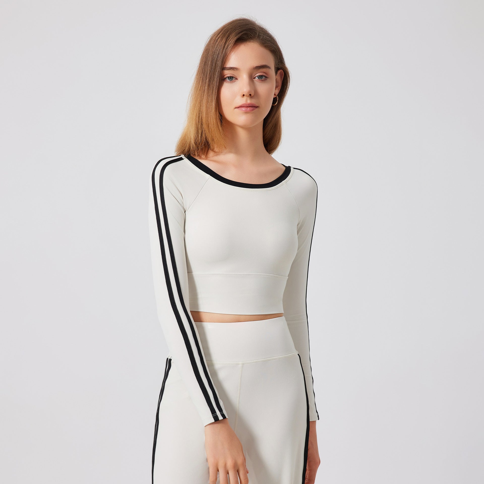 White long-sleeved crop top with black trim from Langry fashion, ideal for ملابس sports wear