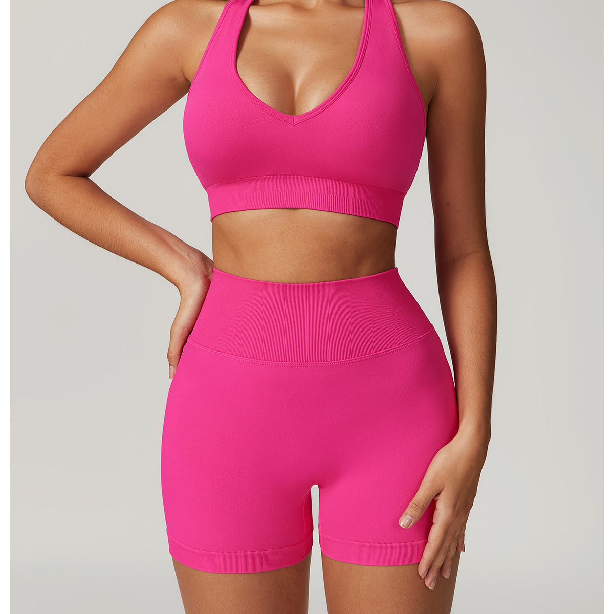 Hot pink athletic set featuring a seamless yoga suit with bra shorts Rhino design