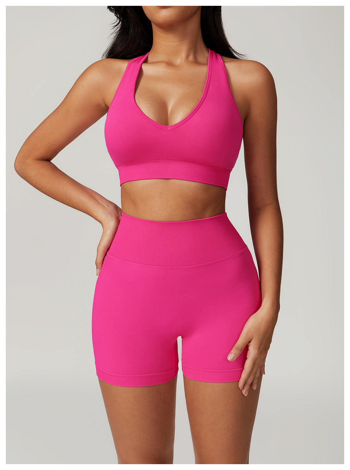 Hot pink athletic set featuring a seamless yoga suit with bra shorts Rhino design