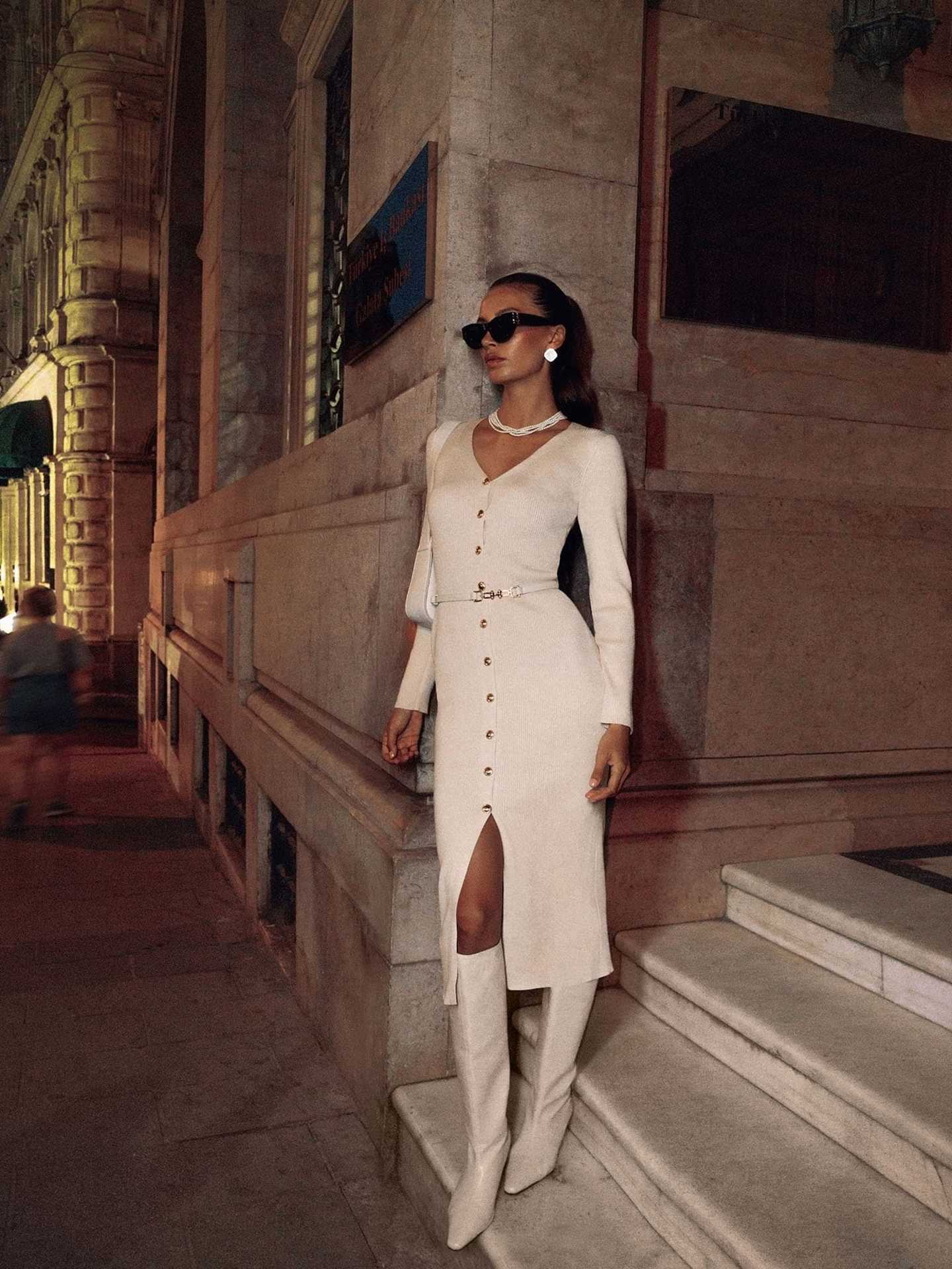 Elegant woman in a white long sleeve knitted dress with boots showcasing Langry fashion