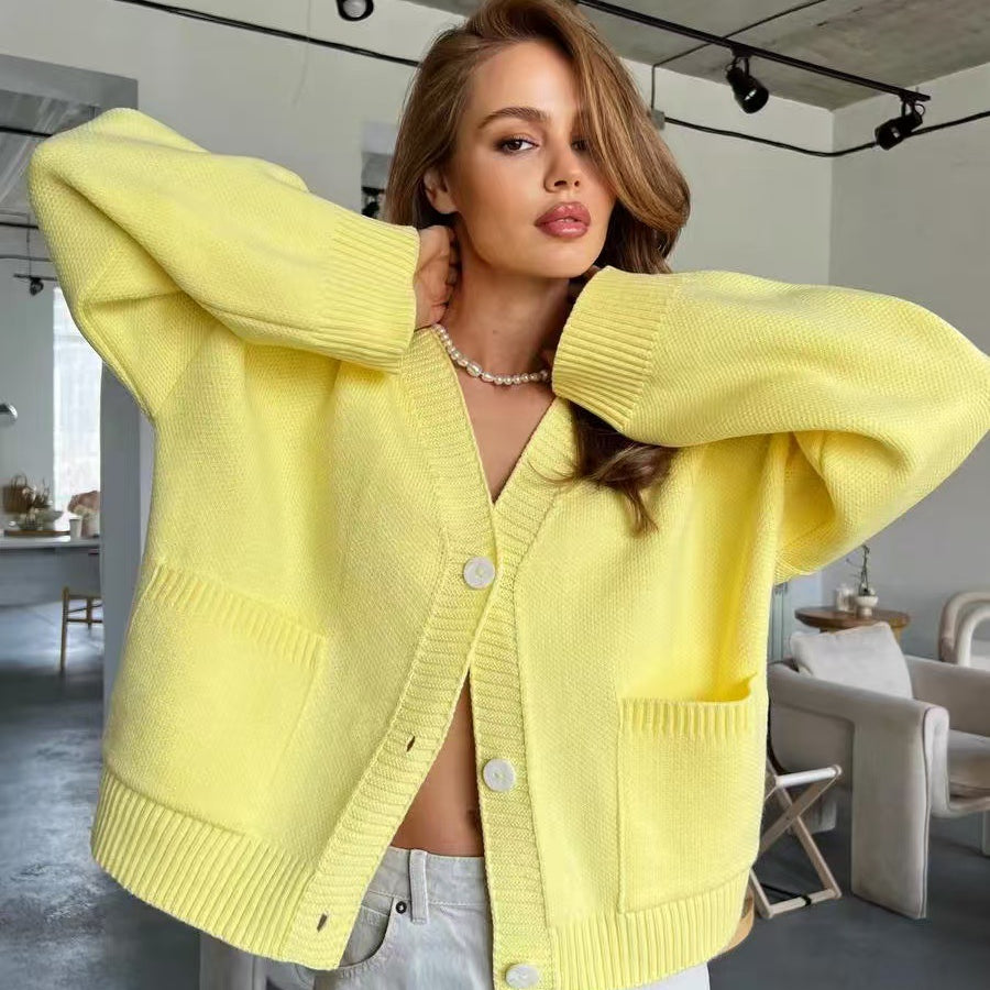 Yellow knitted cardigan sweater coat with soft design, buttons, and pockets