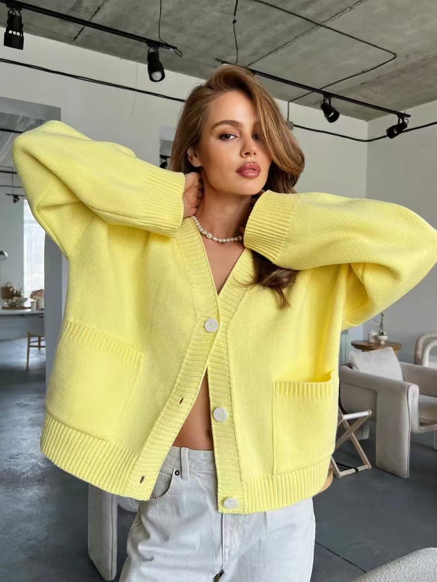 Yellow knitted cardigan sweater coat with soft design, buttons, and pockets
