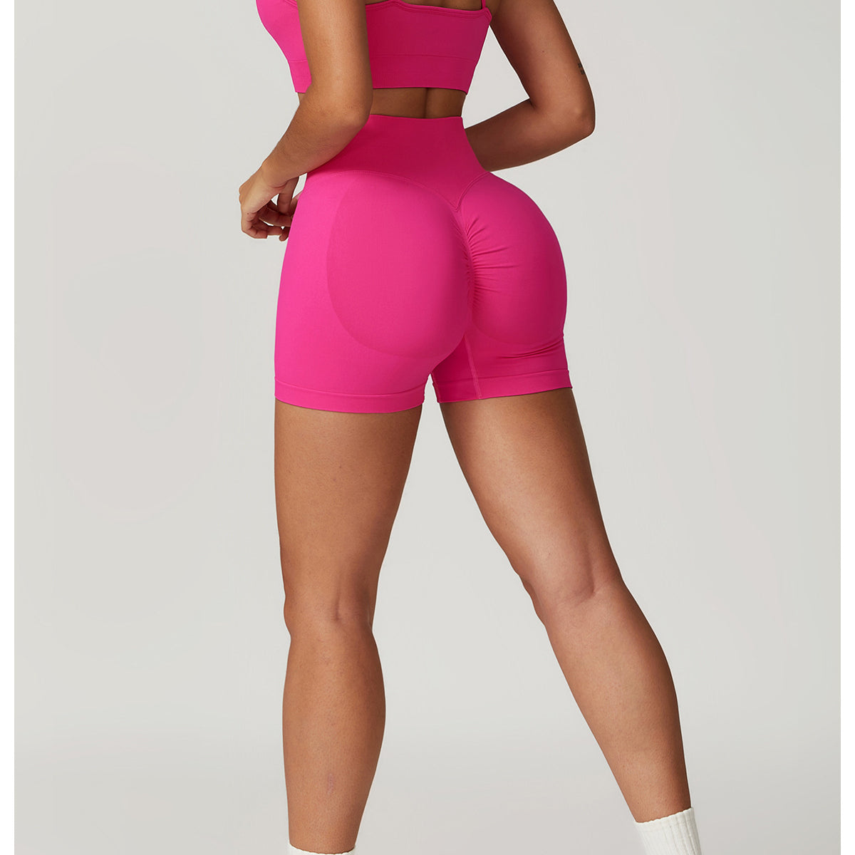 Pink athletic set featuring Seamless Yoga Suit with bra shorts for optimal comfort