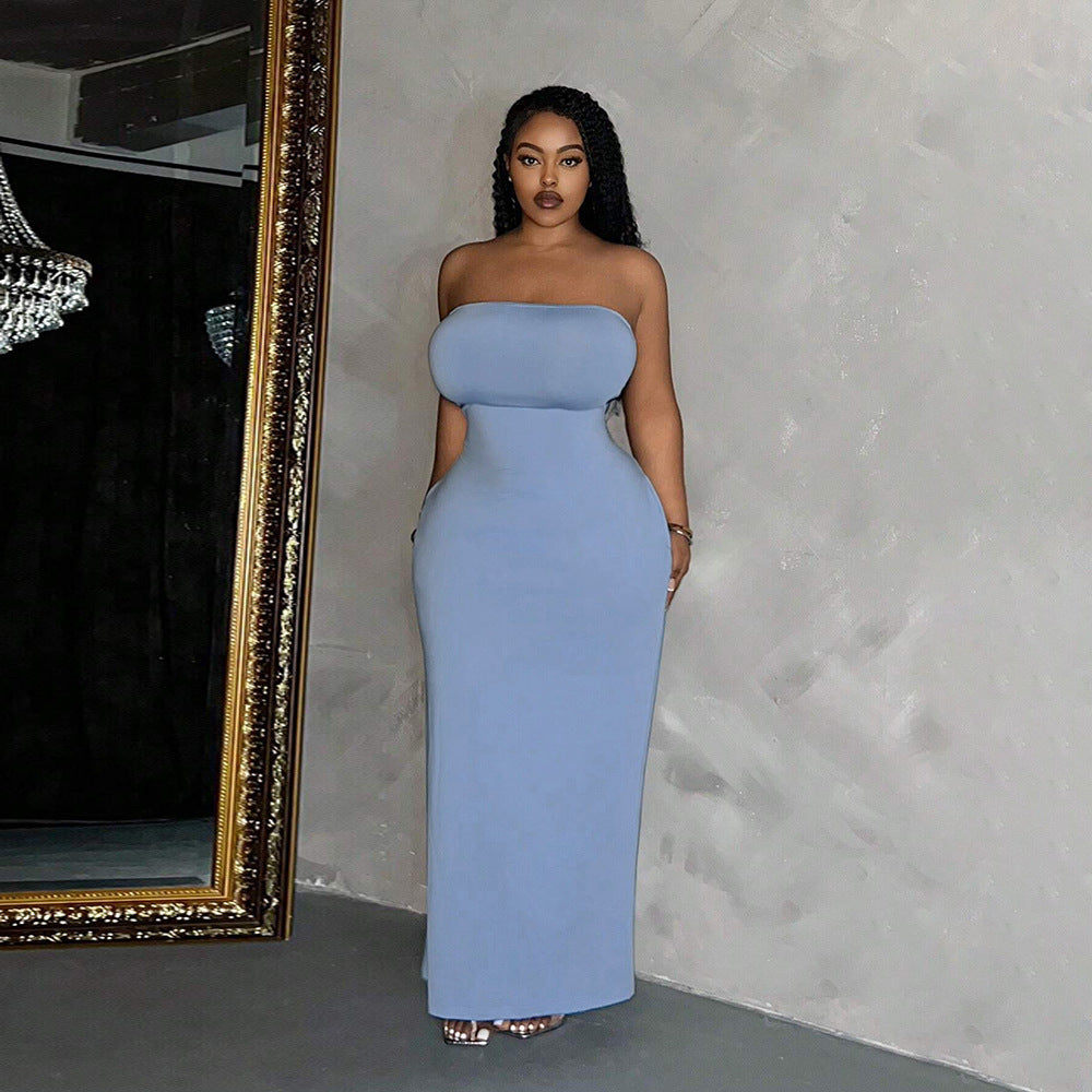 Woman in strapless blue maxi dress showcasing elegant fashion styling