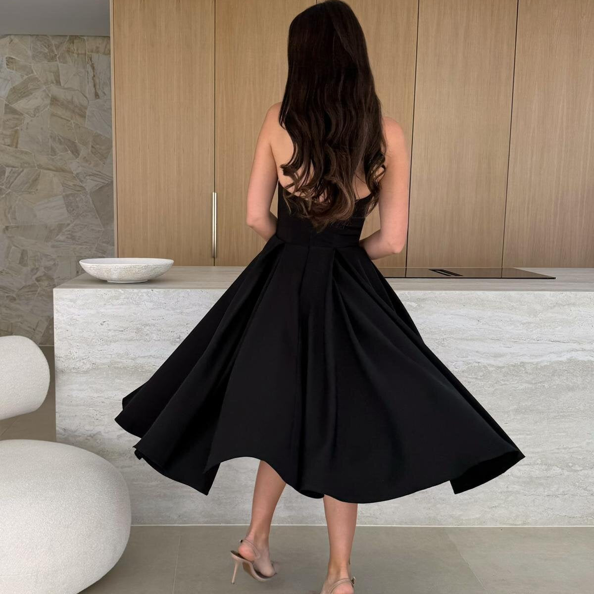 Woman in a black dress showcasing the Gorgeous Midi Dress, a stylish langry fashion ملابس choice