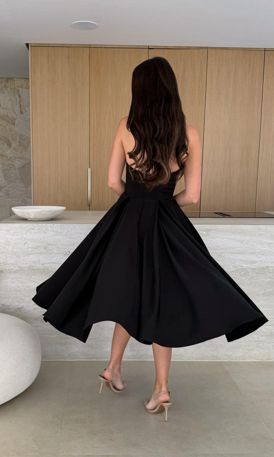 Woman in a black dress showcasing the Gorgeous Midi Dress, a stylish langry fashion ملابس choice