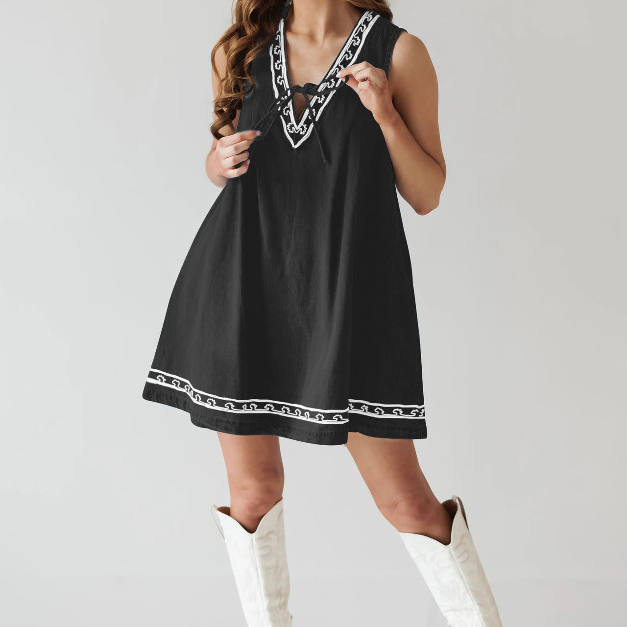 Black dress with white trim and boots, a stylish piece from Beautiful Embroidered Vest Denim Dress