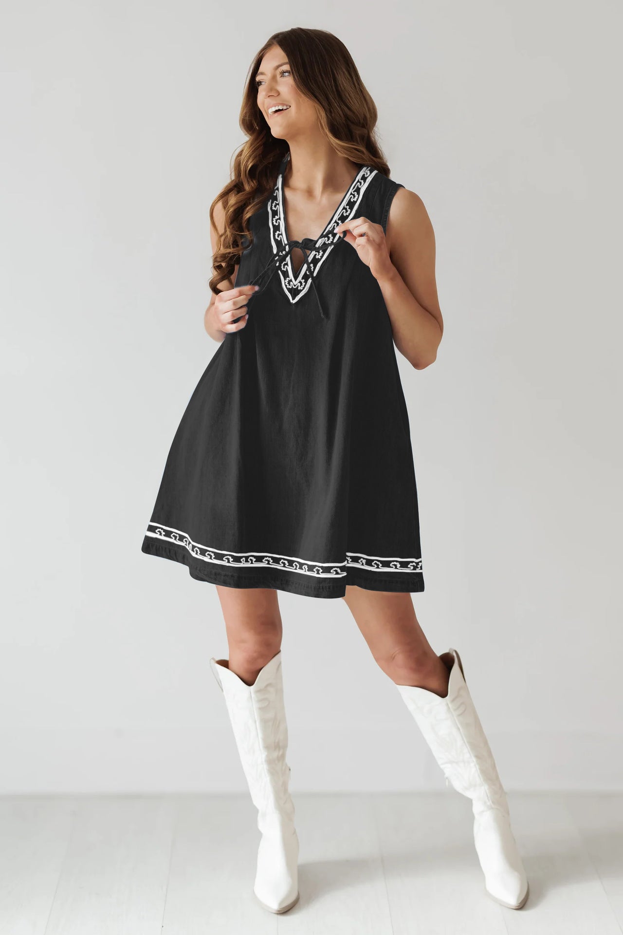 Black dress with white trim and boots, a stylish piece from Beautiful Embroidered Vest Denim Dress