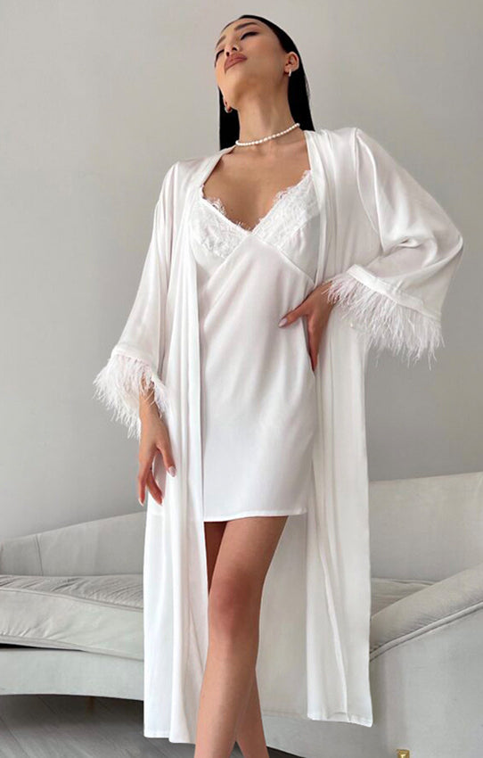 White silk robe with feather trim over a matching slip dress for luxurious homewear