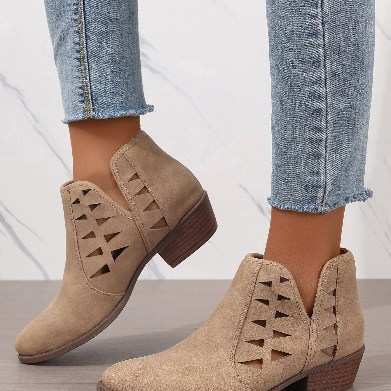 Beige suede ankle boots with triangular cutout patterns for daily ankle style