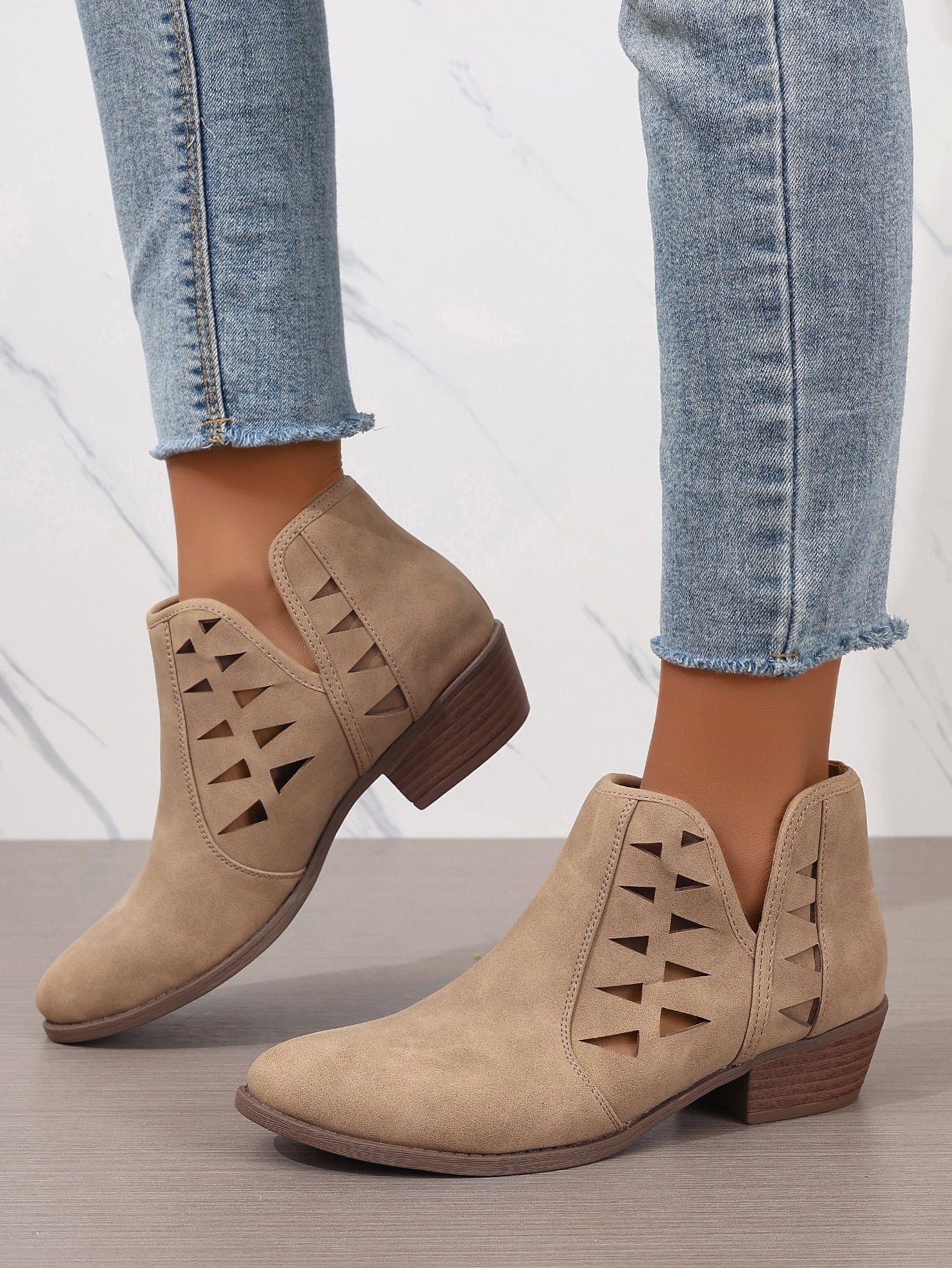 Beige suede ankle boots with triangular cutout patterns for daily ankle style