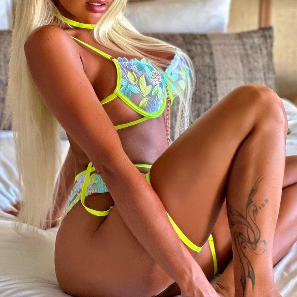 Blonde woman in floral lingerie wearing embroidery underwear hanging neckband with iron chain