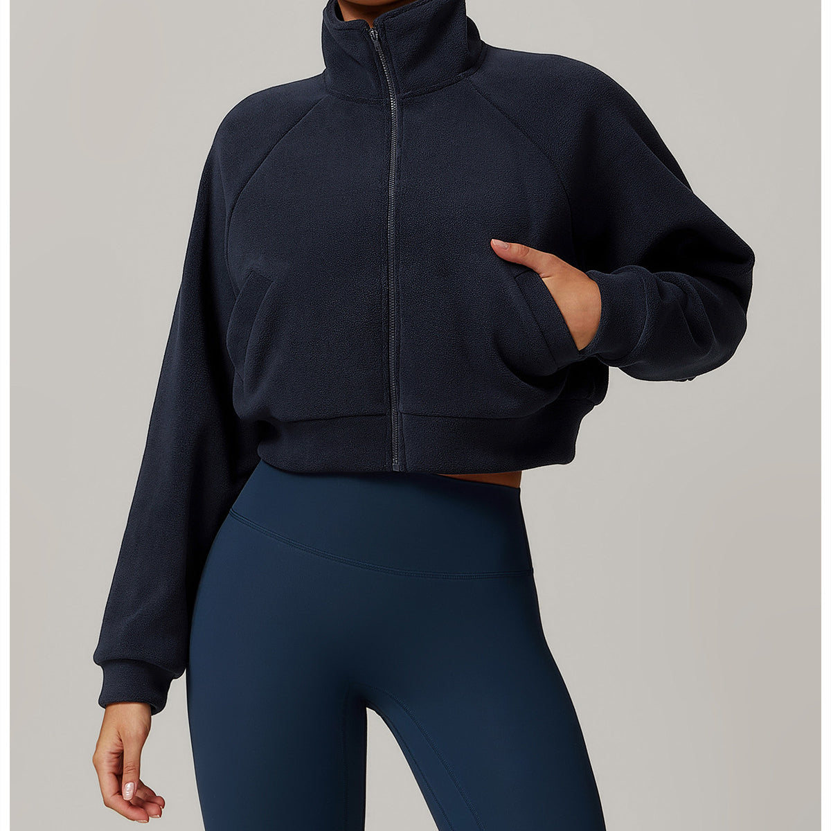 Cropped navy blue zip-up fleece jacket, ideal for langry fashion and fitness activities