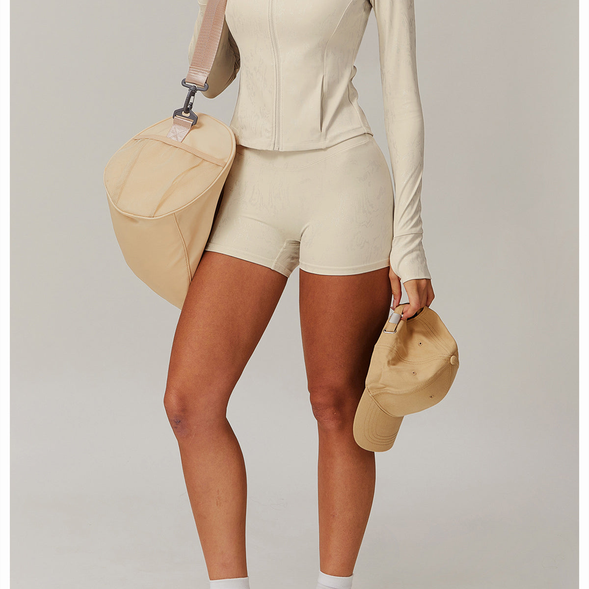 Woman in beige athletic wear, stylish yoga outfit, and matching accessories for langry fashion