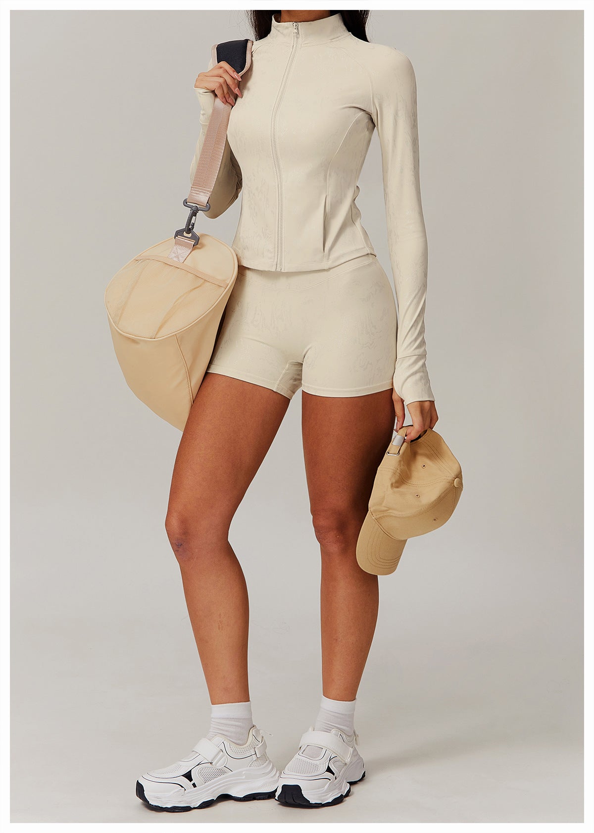 Woman in beige athletic wear, stylish yoga outfit, and matching accessories for langry fashion
