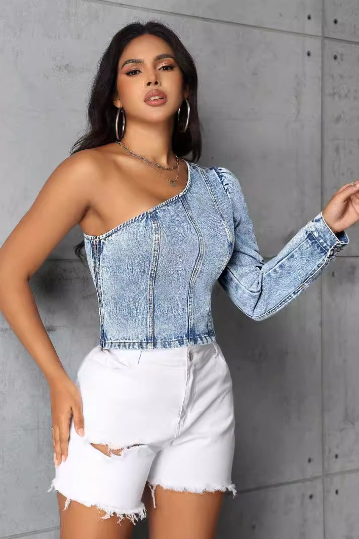 Woman wearing a women slim denim one-shoulder top and distressed white shorts