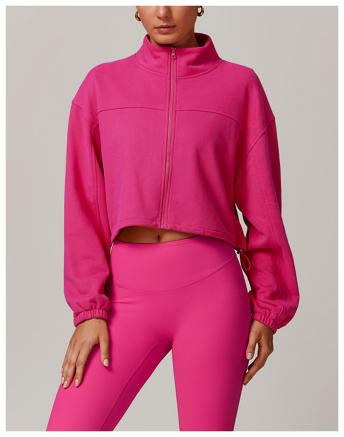 Hot pink cropped zip-up athletic jacket with matching leggings for stylish fitness wear