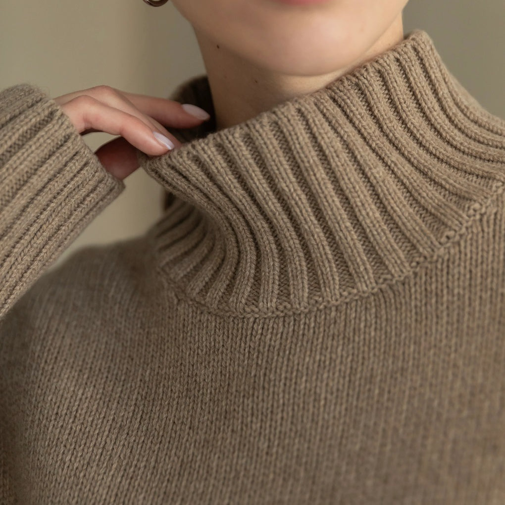 Beige ribbed Langry turtleneck sweater with gold hoop earrings, winter fashion knitwear