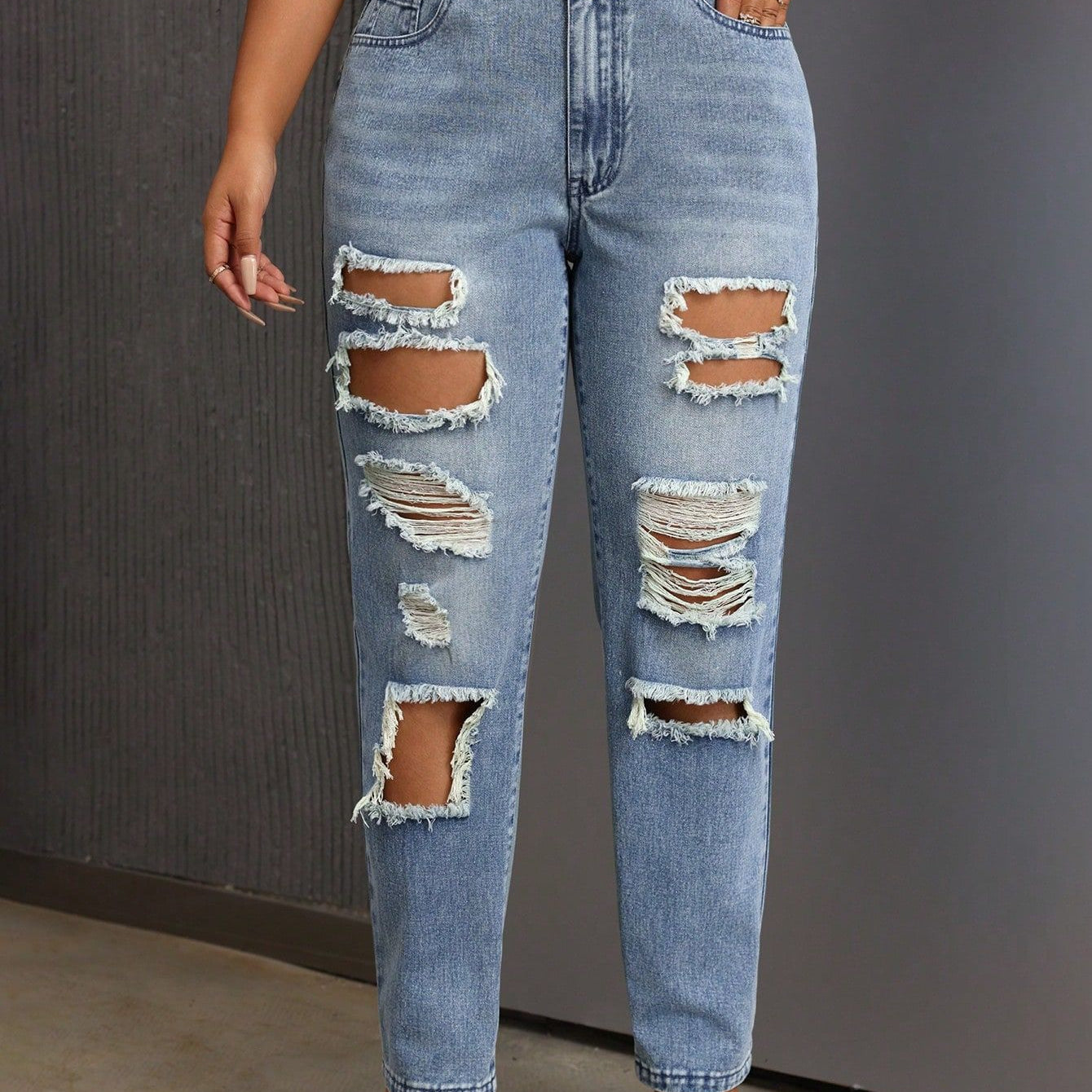 Light blue distressed slimming skinny ripped jeans with multiple rips for a trendy look
