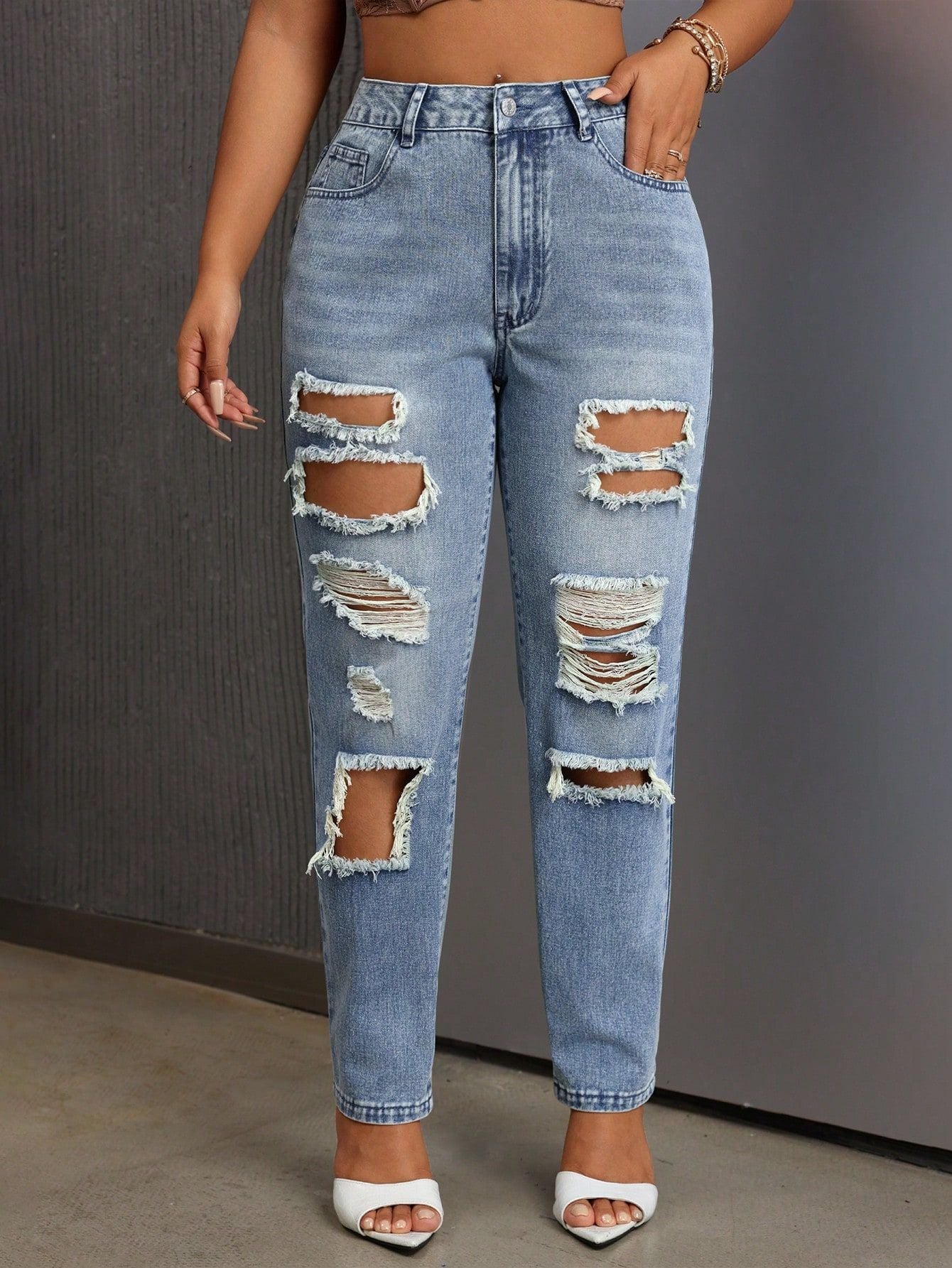 Light blue distressed slimming skinny ripped jeans with multiple rips for a trendy look