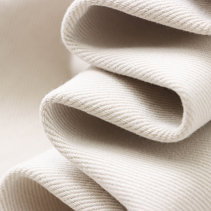 Folded white fabric with ribbed texture showcasing soft waves for Street Design Wide Leg Jeans