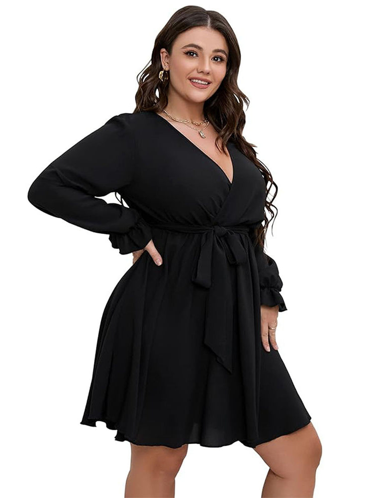 Plus-size woman wearing black winter office midi dress with V-neck and waist tie