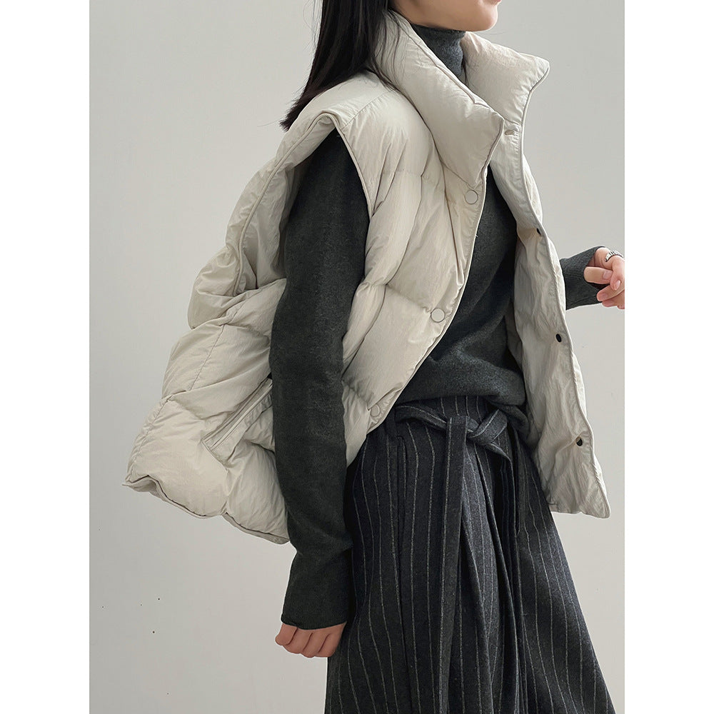Cream-colored quilted puffer vest over a black sweater, perfect for Langry fashion ملابس