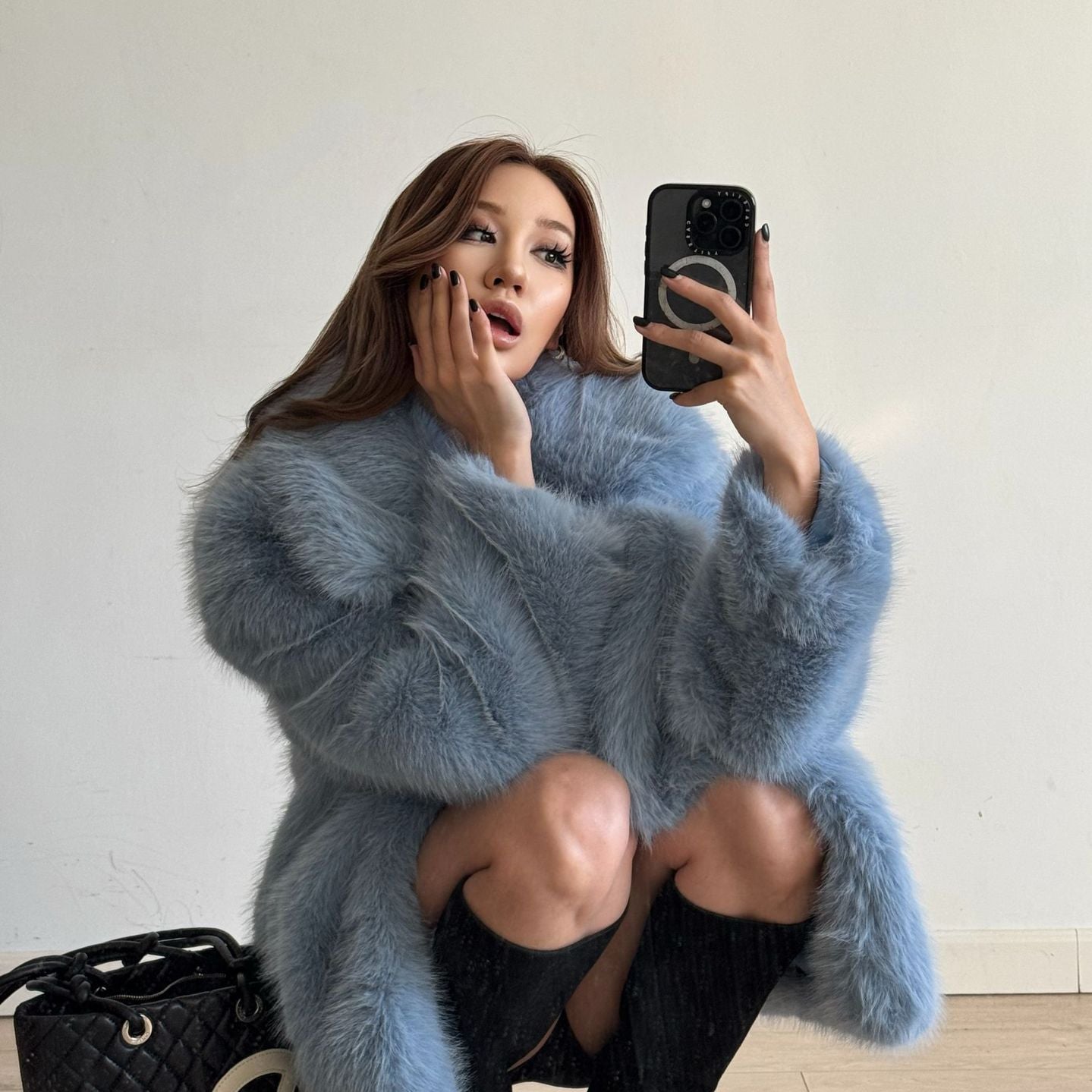 Mid-length Langry fashionable warm faux fur coat in blue with black trim and high-heeled boots