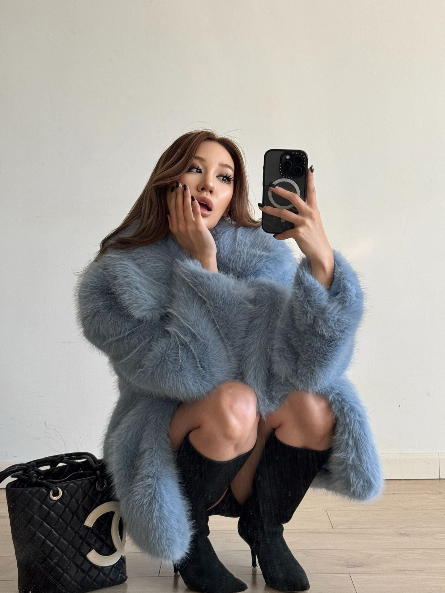 Mid-length Langry fashionable warm faux fur coat in blue with black trim and high-heeled boots