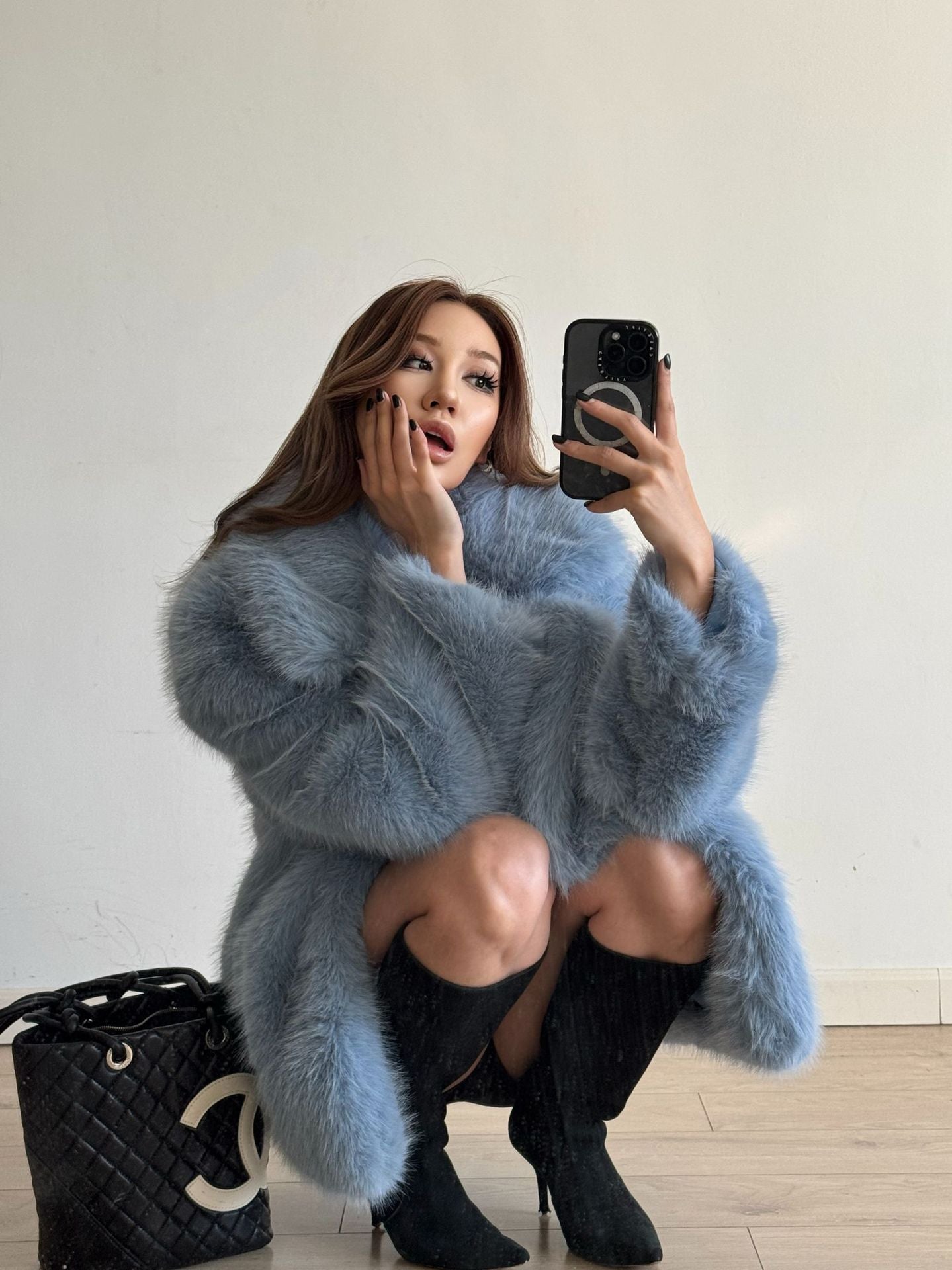 Mid-length Langry fashionable warm faux fur coat in blue with black trim and high-heeled boots