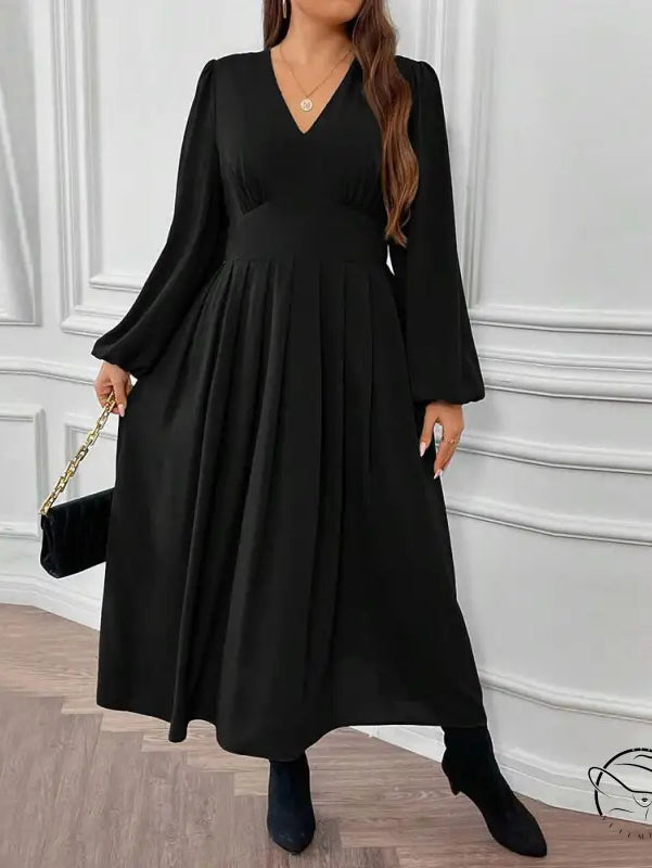 Woman in gorgeous large swing dress with V-neck, pleats, boots, clutch