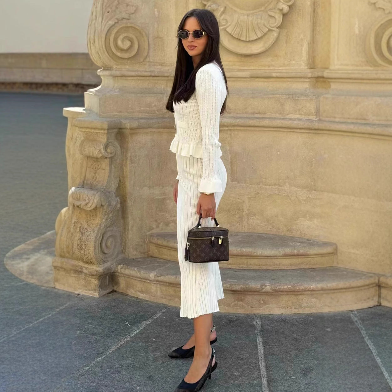 Stylish woman in white knitwear showcasing elegant fashion dress and skirt set