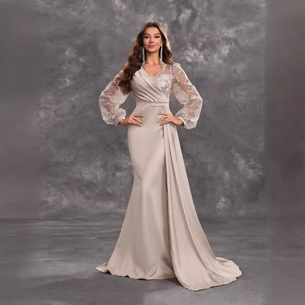 Elegant beige evening gown with sheer embellished sleeves for sophisticated fashion