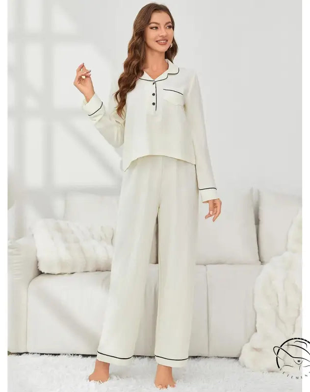 Woman in cream langry fashion pajamas with black piping, autumn winter set
