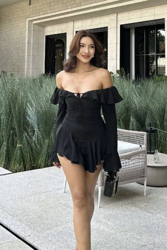 Elegant woman in off-the-shoulder black dress showcasing fashionable ملابس for trendy style